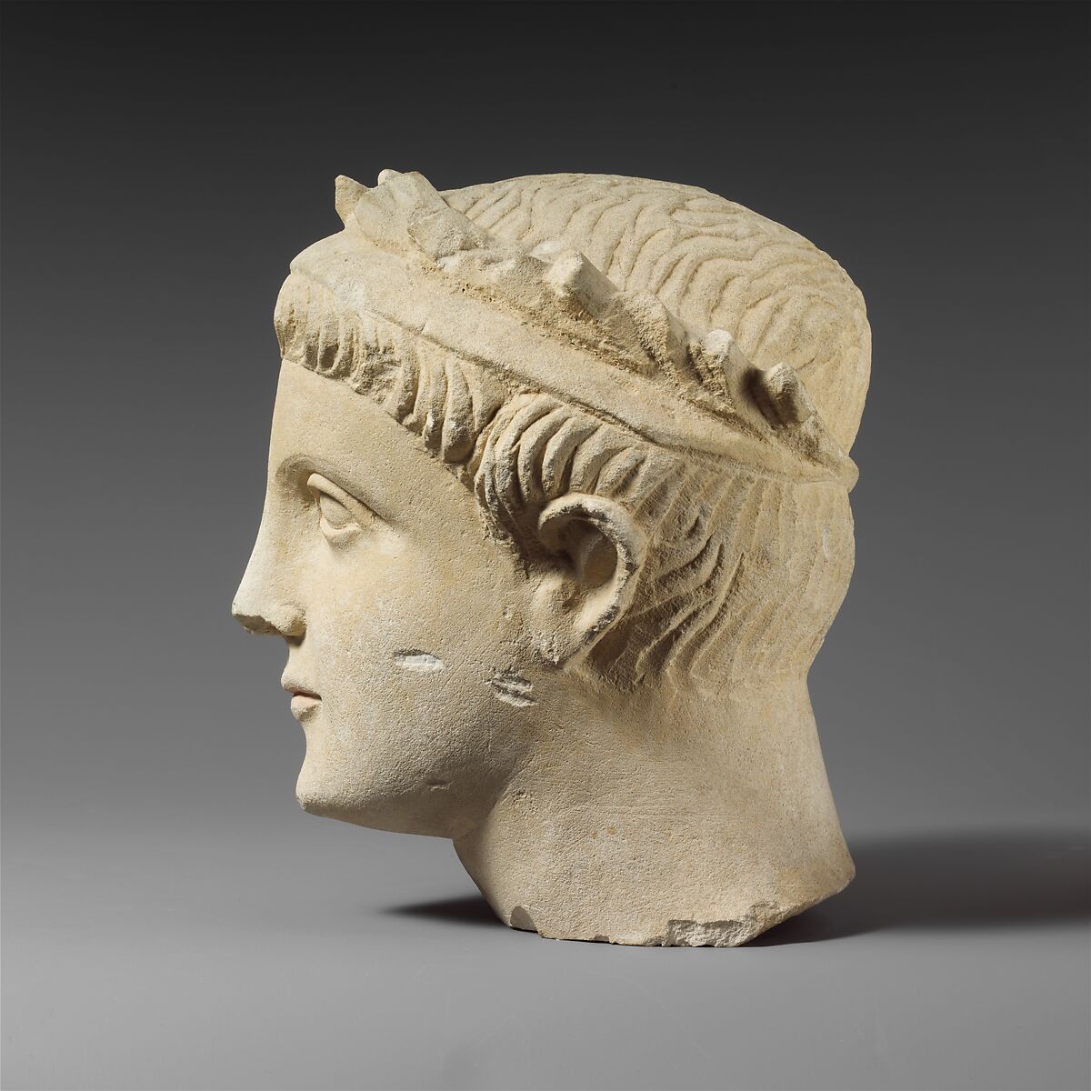 Limestone head of a wreathed youth, Limestone, Cypriot