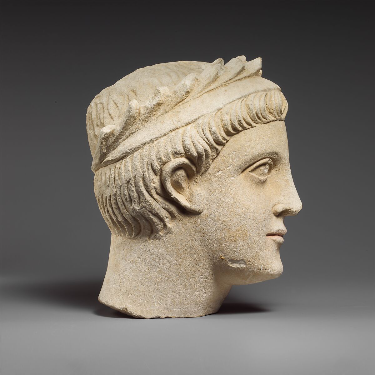 Limestone head of a wreathed youth, Limestone, Cypriot