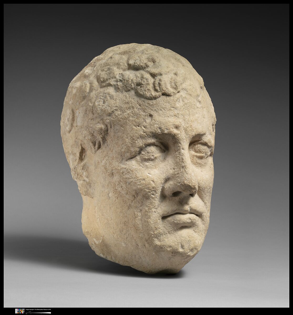 Limestone head of beardless male votary, Limestone, Cypriot