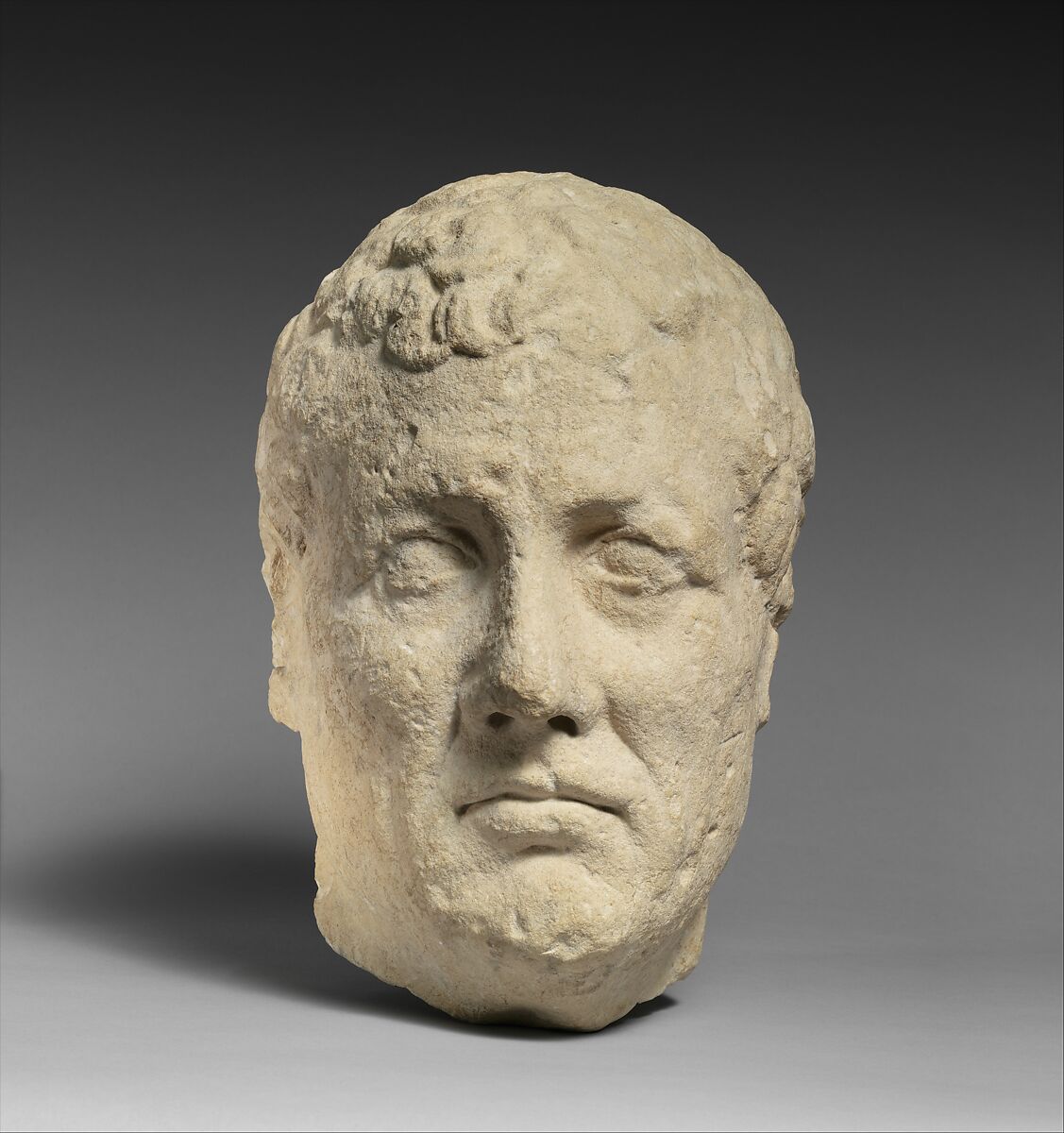 Limestone head of beardless male votary, Limestone, Cypriot 