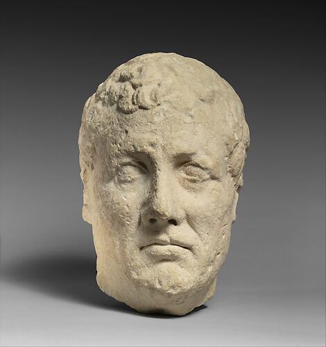 Limestone head of beardless male votary