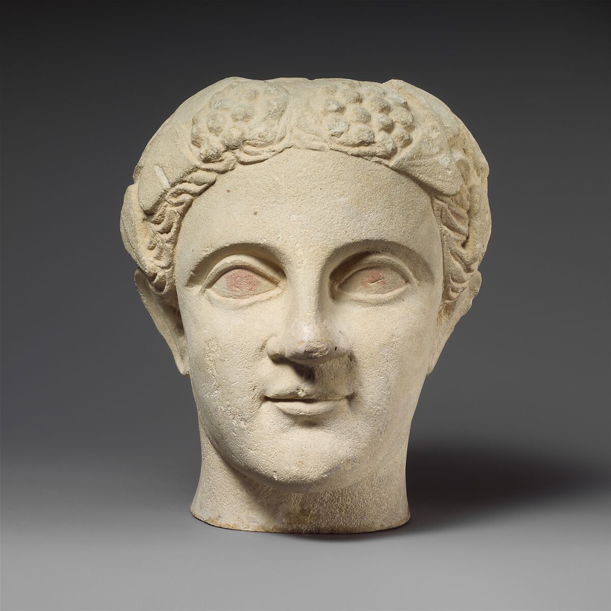 Limestone head of a wreathed youth, Limestone, Cypriot 