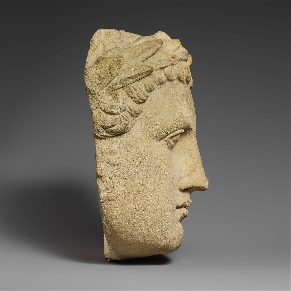 Limestone head of beardless male votary, Limestone, Cypriot