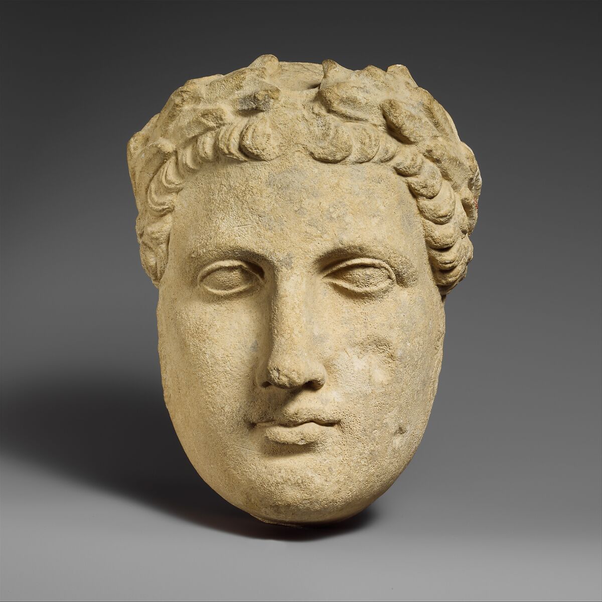 Limestone head of beardless male votary, Limestone, Cypriot 