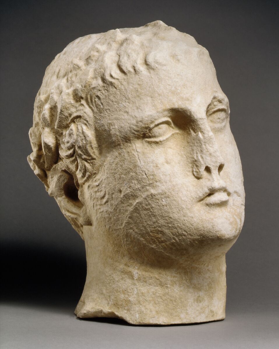Limestone head of beardless male votary with wreath of leaves, Limestone, Cypriot