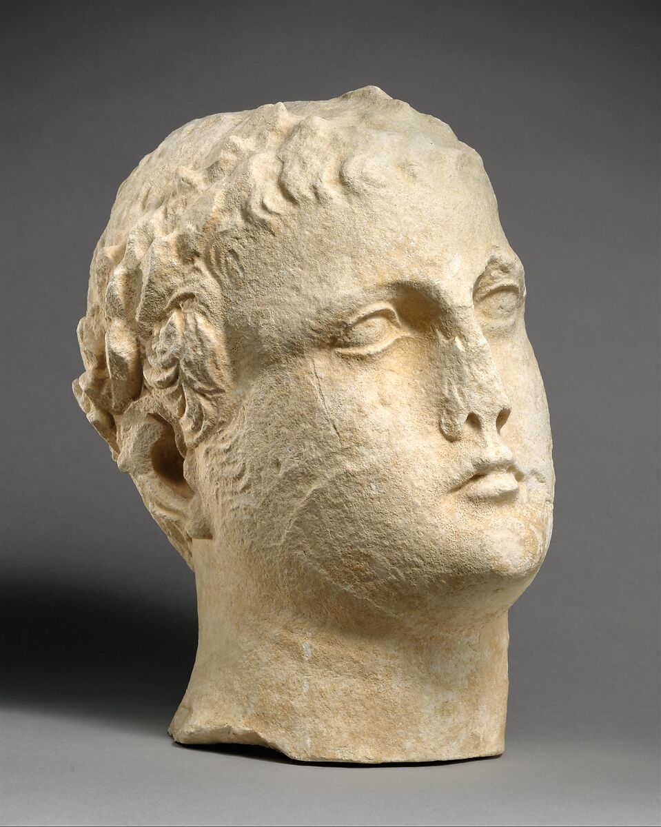 Limestone head of beardless male votary with wreath of leaves, Limestone, Cypriot 