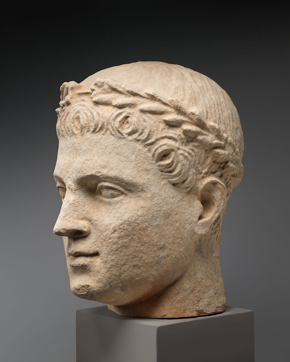 Limestone head of beardless male votary with wreath of leaves, Limestone, Cypriot