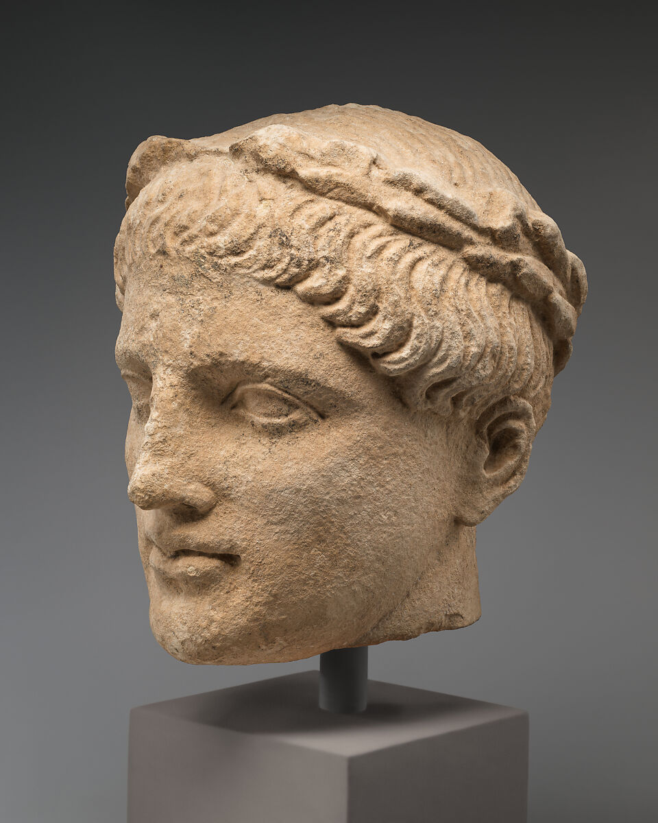 Limestone head of beardless male votary with wreath of leaves, Limestone, Cypriot