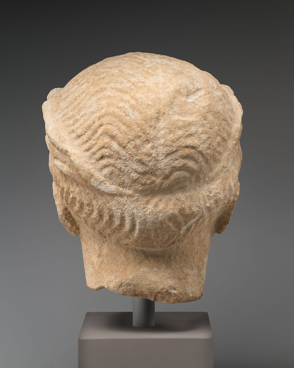 Limestone head of beardless male votary with wreath of leaves, Limestone, Cypriot