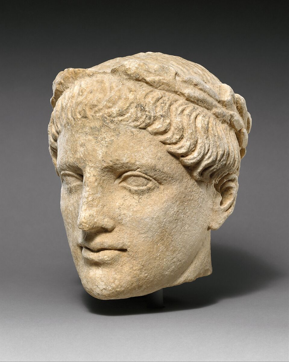 Limestone head of beardless male votary with wreath of leaves, Limestone, Cypriot 