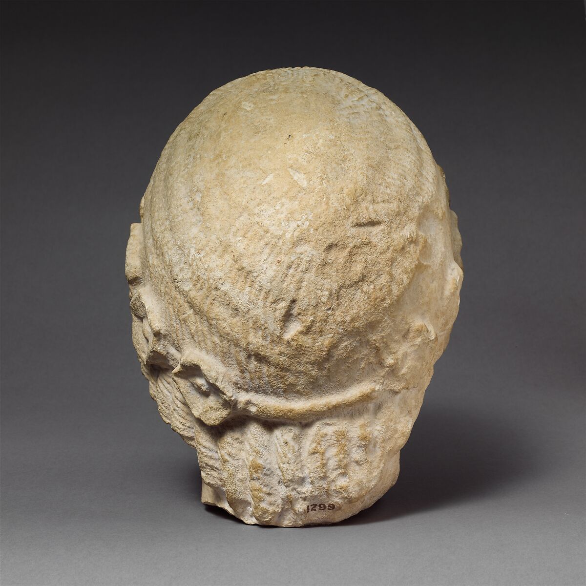 Limestone beardless male head with a wreath of rosettes, Limestone, Cypriot