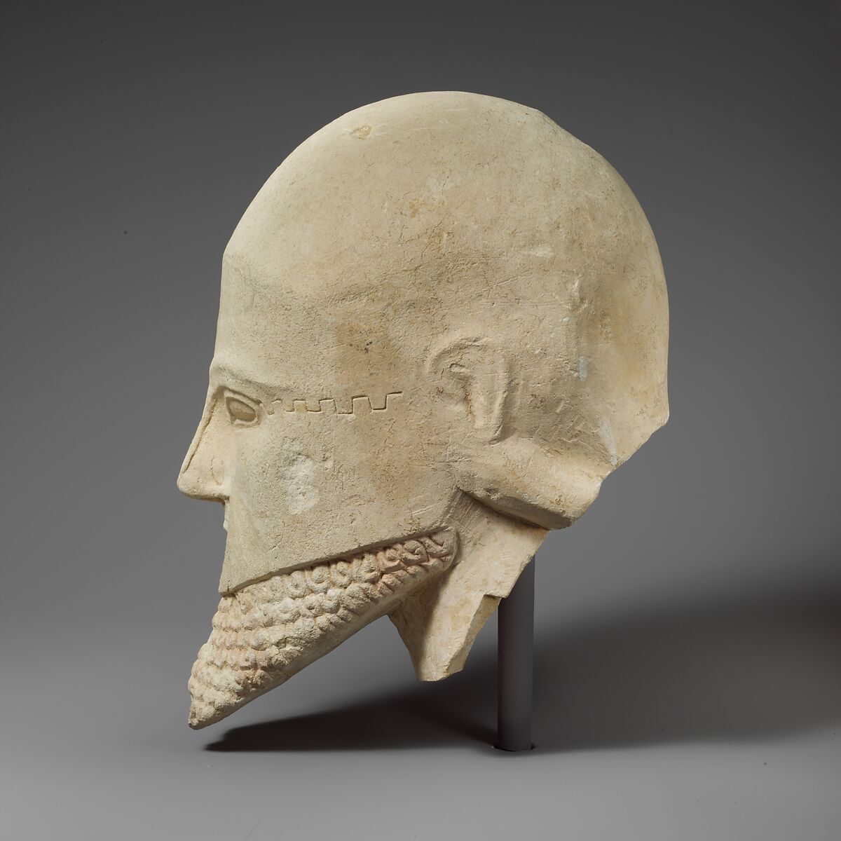 Limestone bearded head with a Corinthian helmet, Limestone, Cypriot