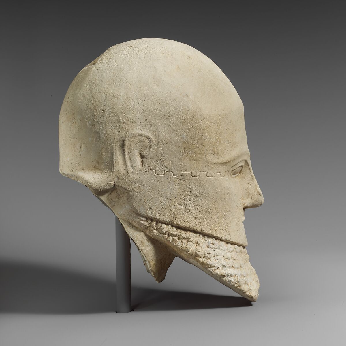 Limestone bearded head with a Corinthian helmet, Limestone, Cypriot