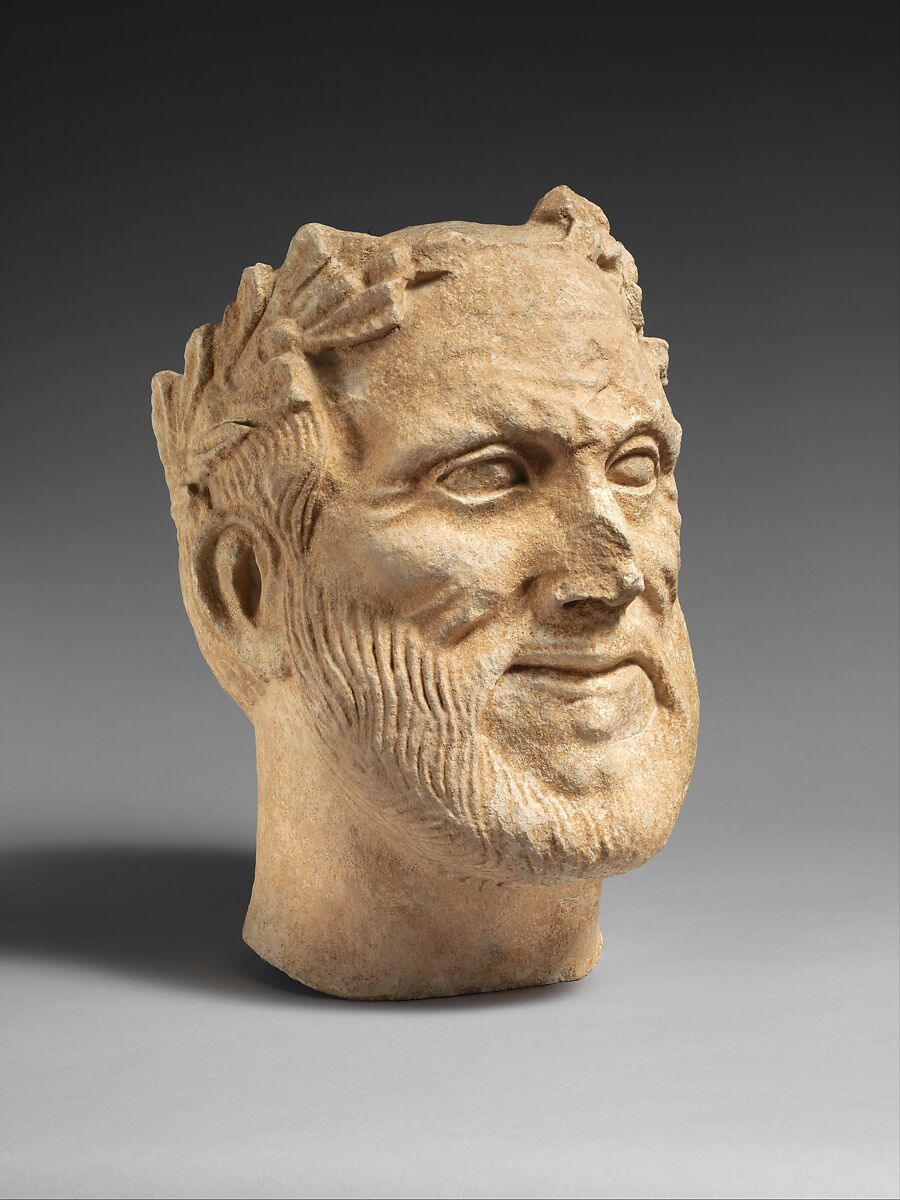 Limestone head of bearded male votary with wreath of leaves, Limestone, Cypriot