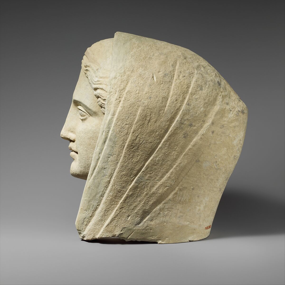 Limestone head of a veiled female votary, Limestone, Cypriot