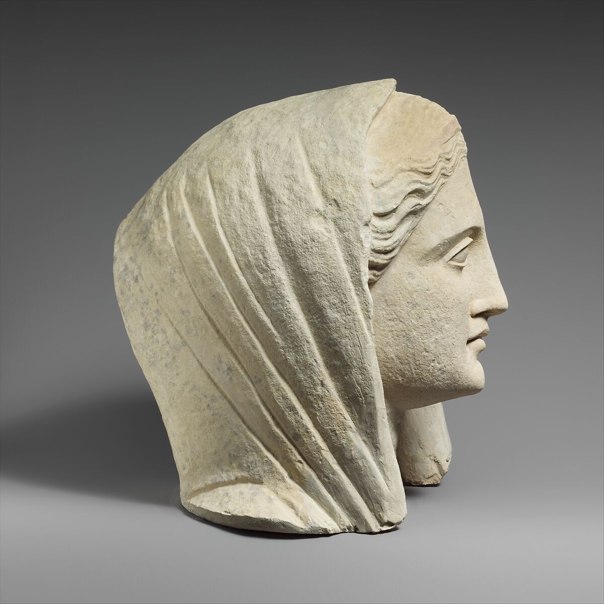 Limestone head of a veiled female votary, Limestone, Cypriot