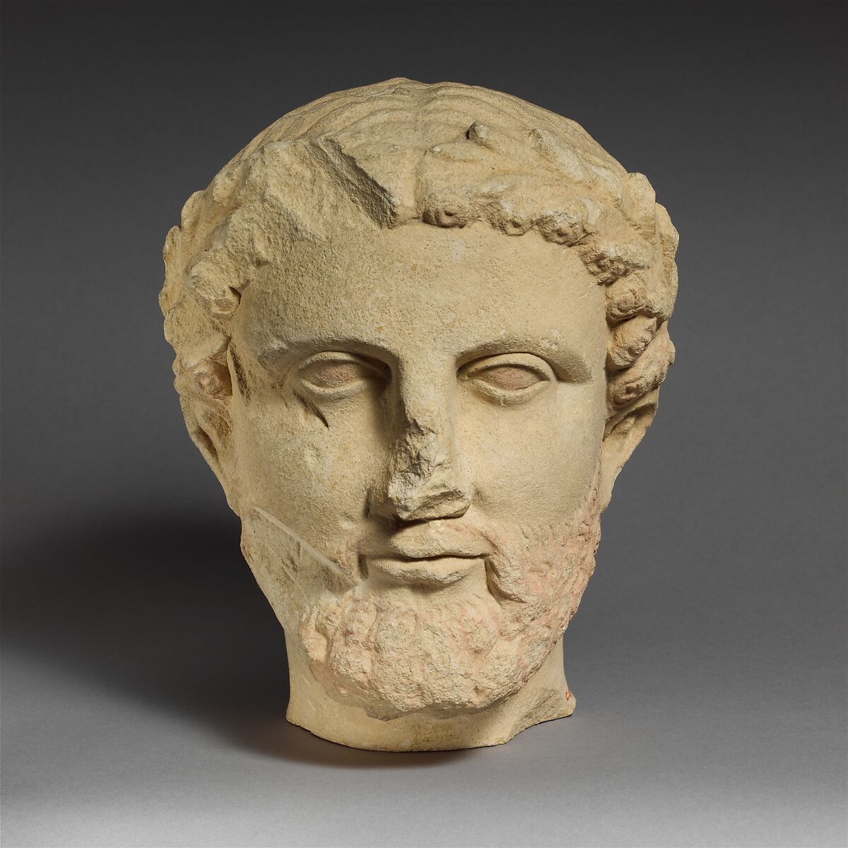 Limestone bearded head with a wreath of leaves, Limestone, Cypriot 
