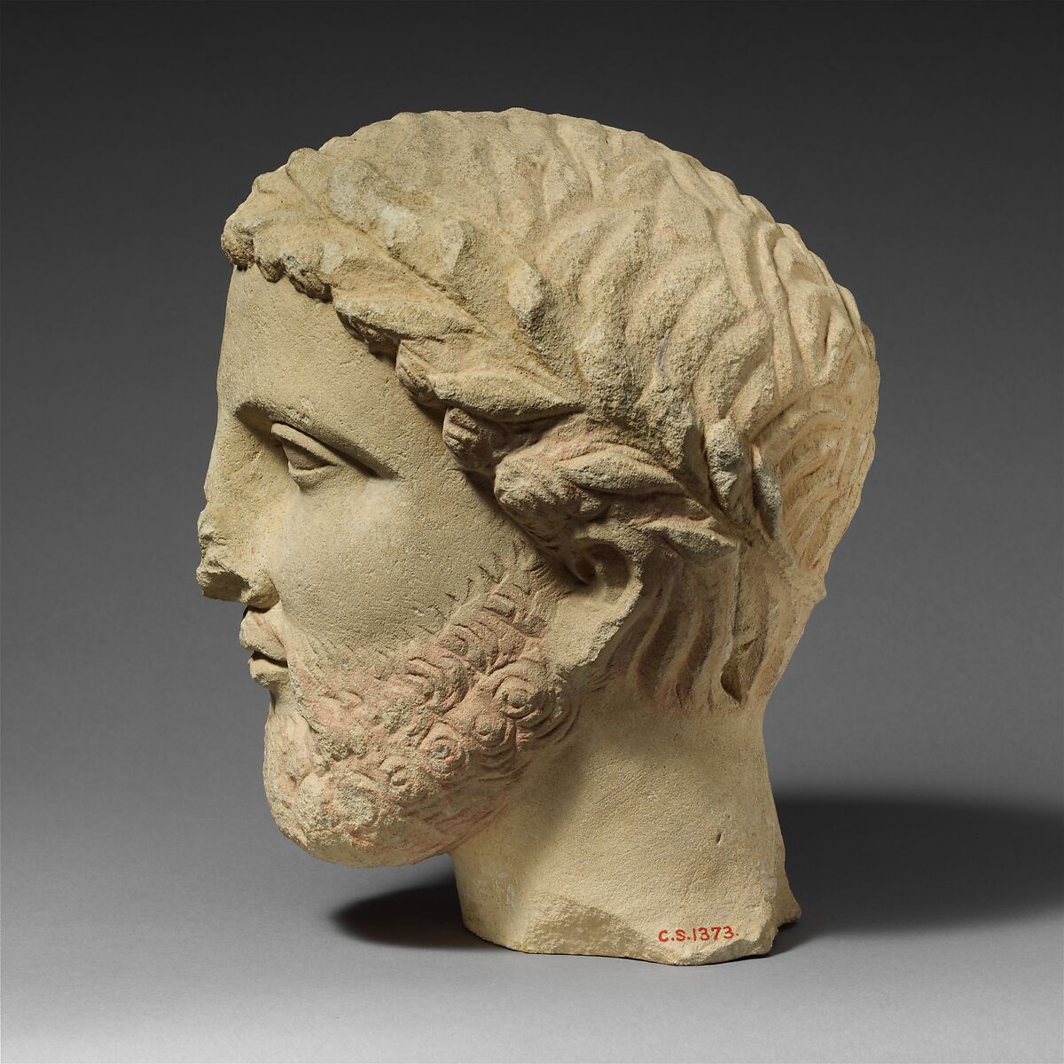 Limestone bearded head with a wreath of leaves, Limestone, Cypriot