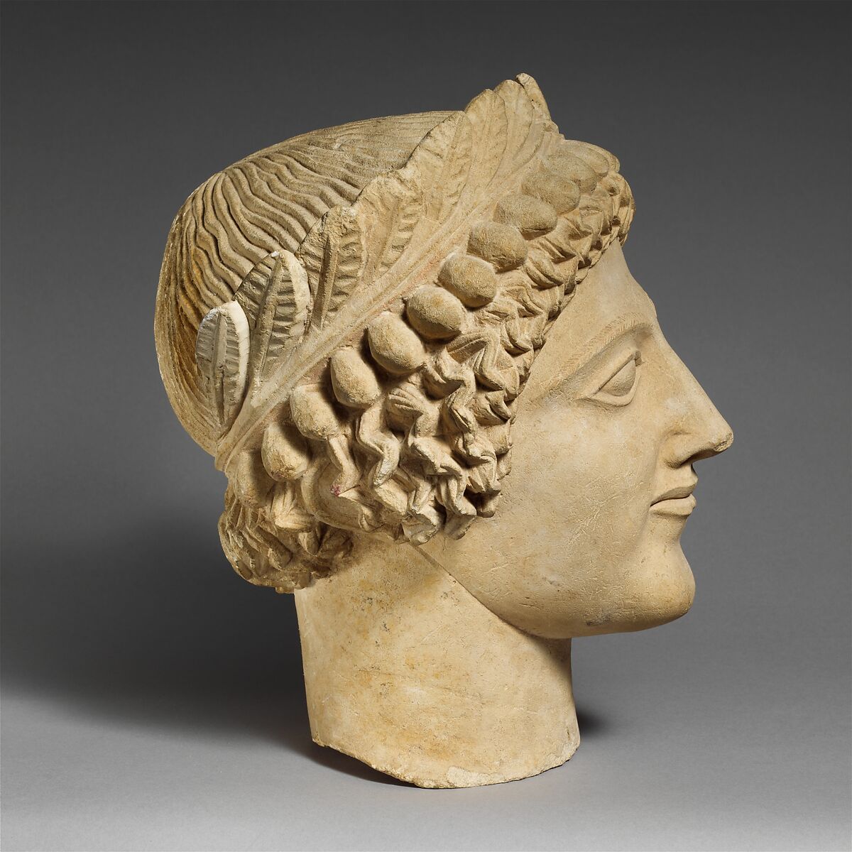Limestone head of a youth with wreath, Limestone, Cypriot