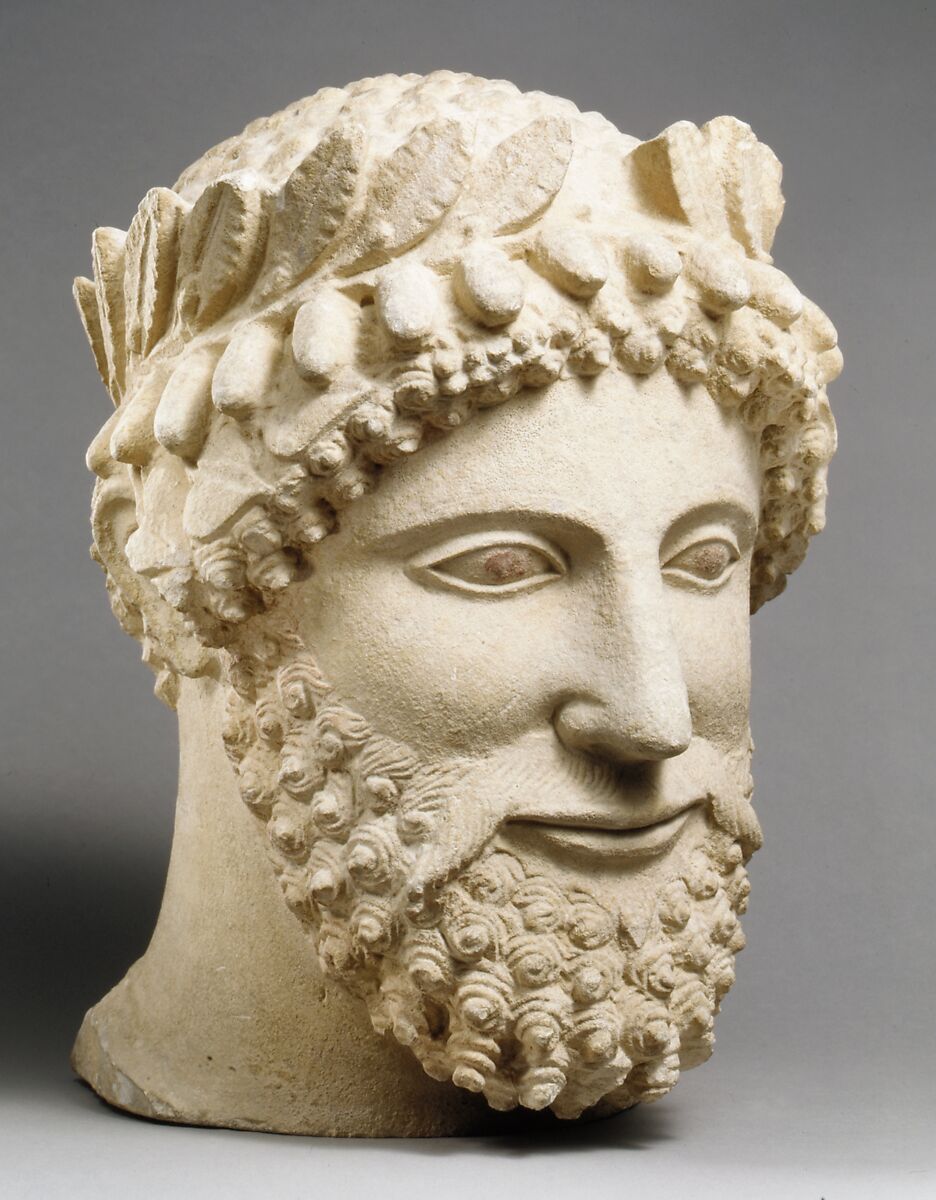 Limestone head of a bearded man wearing a wreath, Limestone, Cypriot