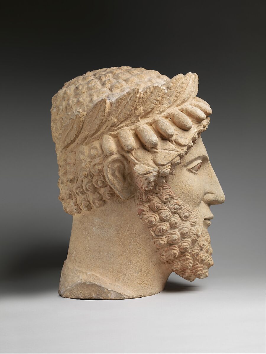 Limestone head of a bearded man wearing a wreath, Limestone, Cypriot