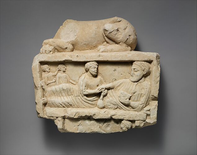 Limestone finial of a funerary stele with a recumbent lion and a banquet scene
