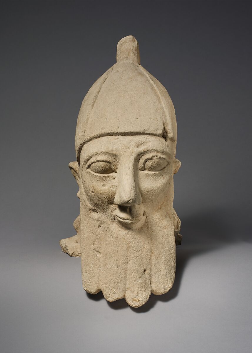 Over-lifesize bearded head wearing a conical helmet, Limestone, Cypriot 