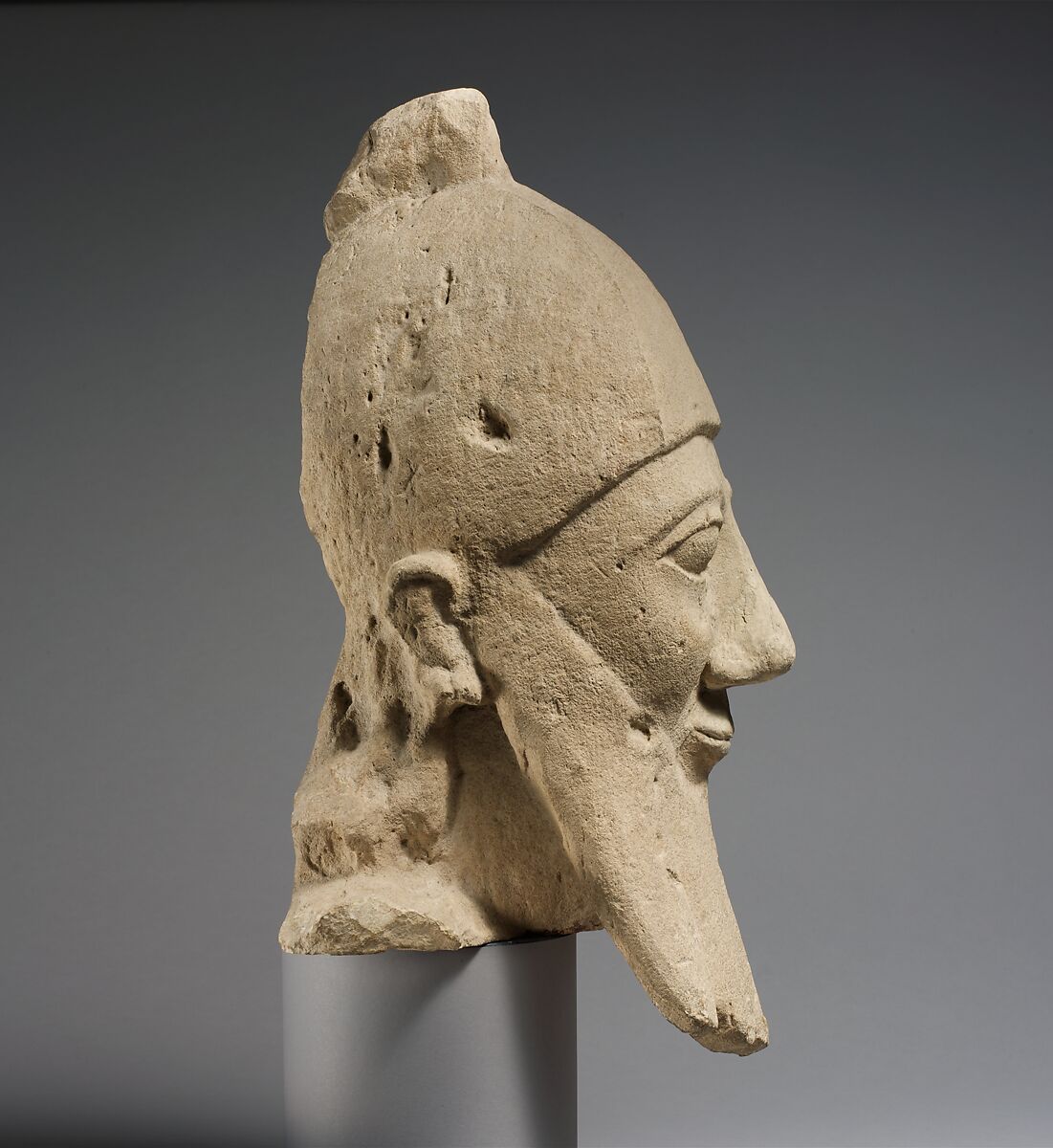 Over-lifesize bearded head wearing a conical helmet, Limestone, Cypriot