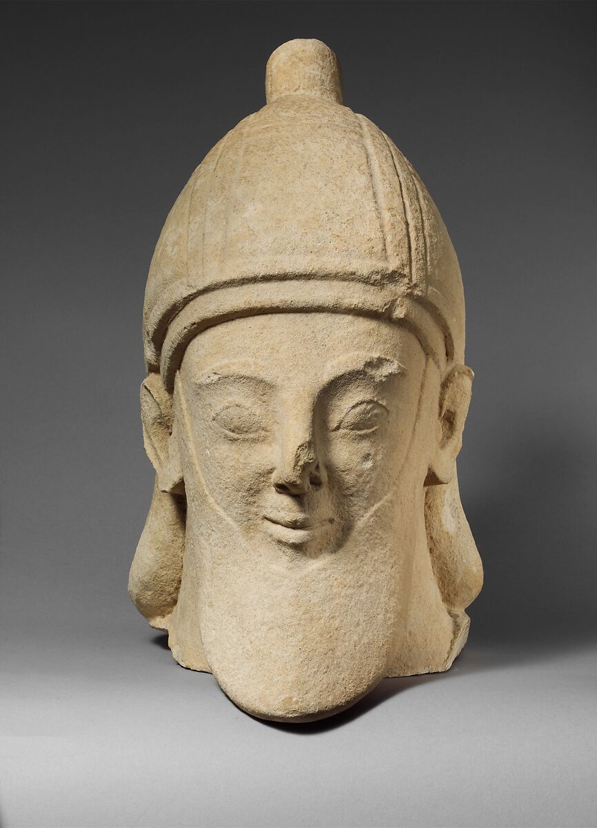 Limestone head of a bearded male wearing a conical helmet, Limestone, Cypriot 