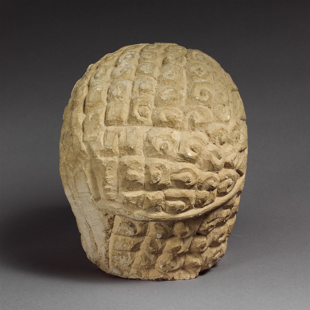Limestone head of a bearded male with a wreath of leaves, Limestone, Cypriot