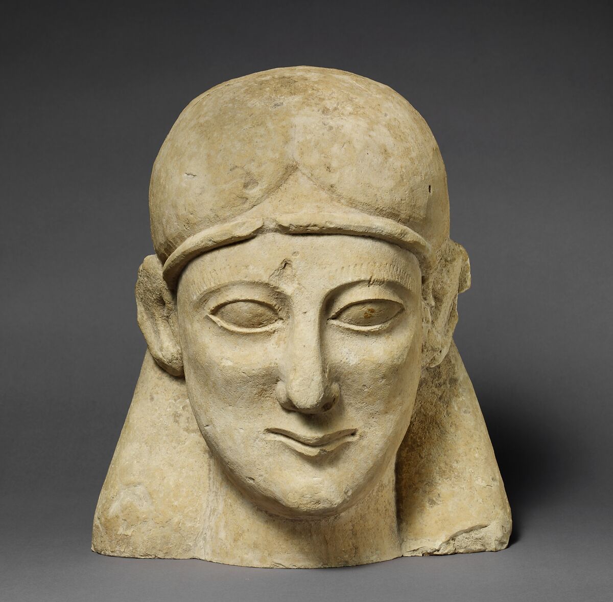 Limestone head of a beardless male with a fillet, Limestone, Cypriot 