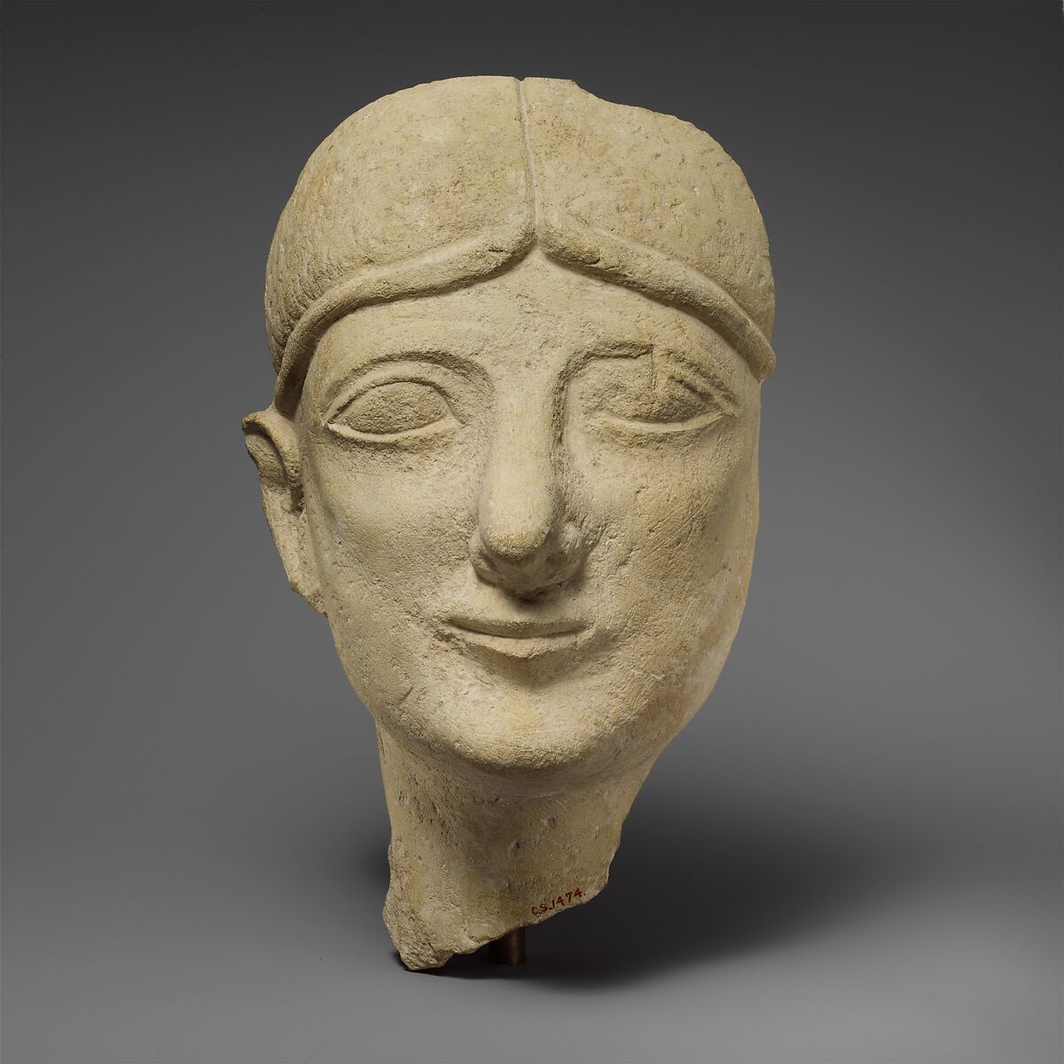 Limestone head of a beardless male with a fillet, Limestone, Cypriot 