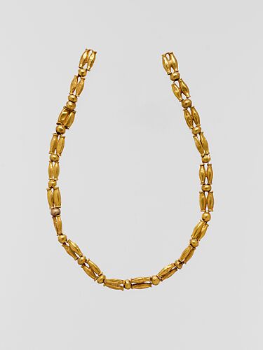 Gold beads, perhaps from a necklace