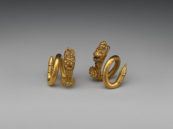 Gold spiral earring with lion-griffin terminal