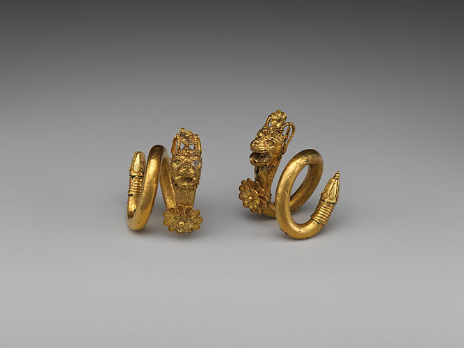 Gold spiral earring with lion-griffin terminal