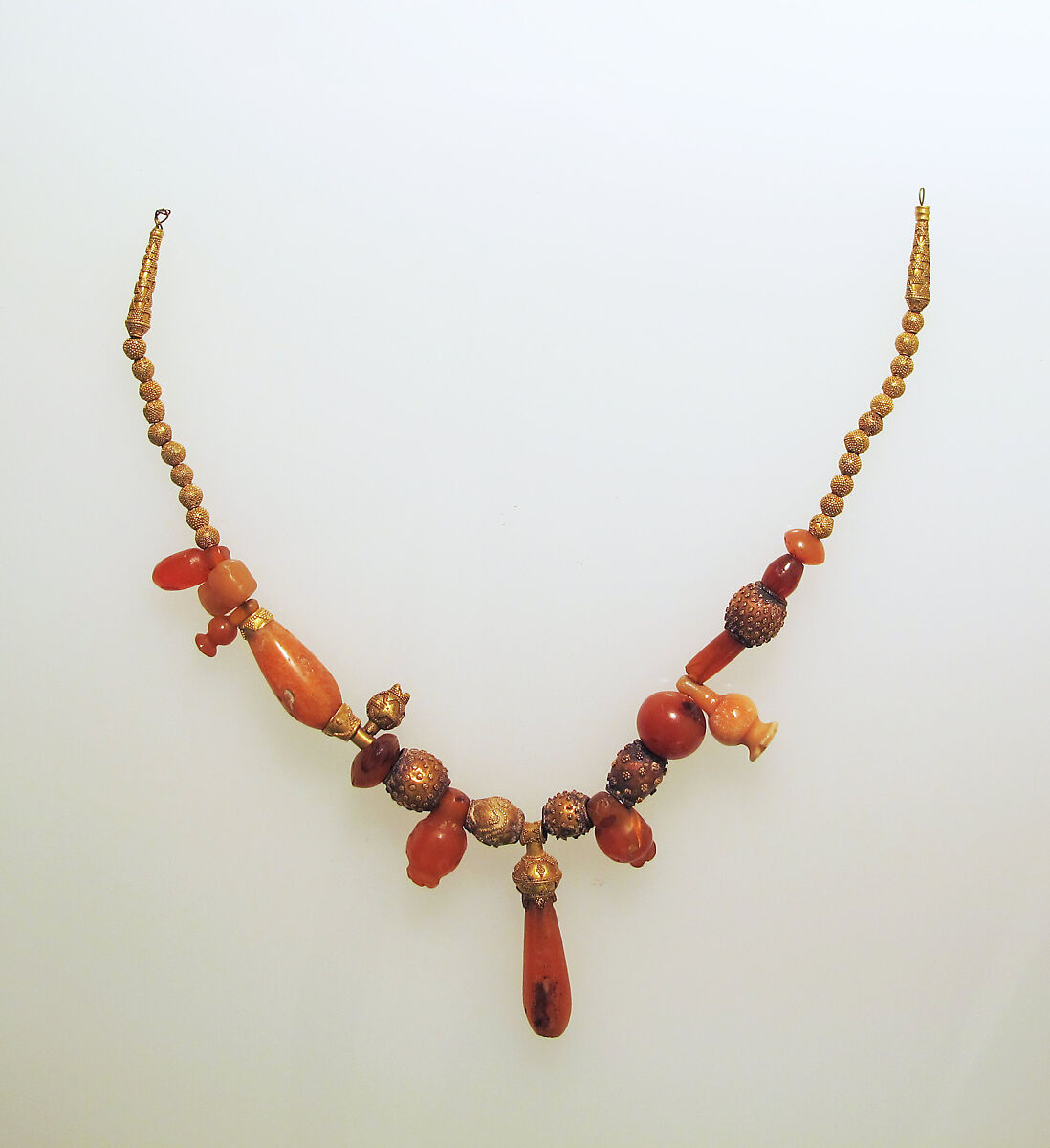 Necklace of assorted gold and carnelian beads, with gold terminals and carnelian pendant, Gold, Cypriot 