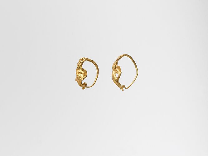 Gold earring with winged figure