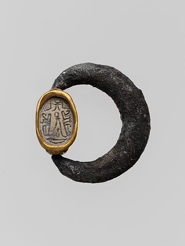Silver swivel ring with glazed steatite scarab in a gold setting