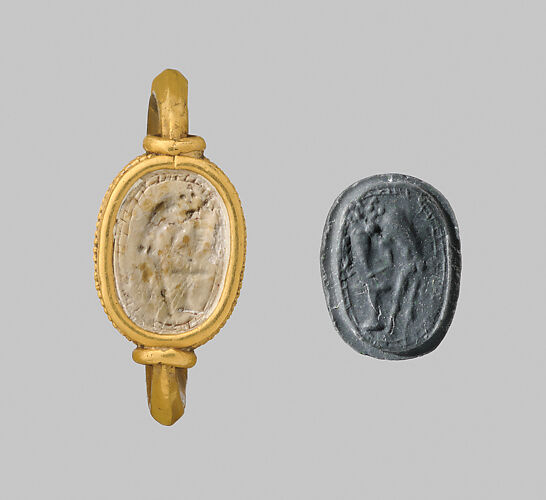 Steatite scaraboid seal set in a gold swivel ring