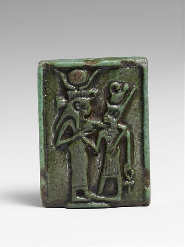 Faience amulet plaque of Isis nourishing a pharaoh