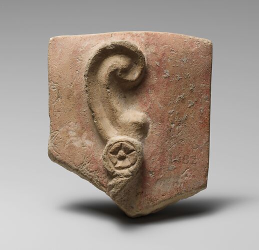 Stone votive relief of an ear with earring