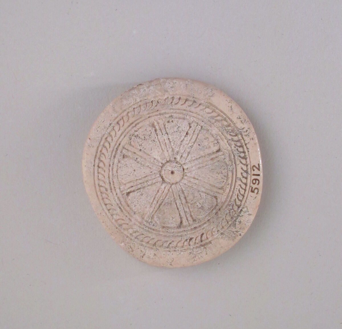 Ivory disk of a pyxis with rosette, Hippoptomus ivory, Cypriot 