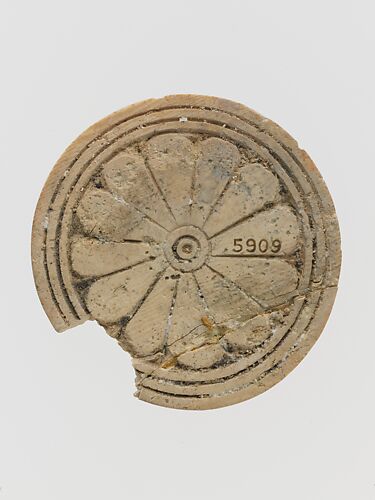 Ivory disk of a pyxis with rosette