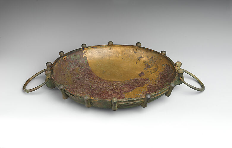 Shallow bronze bowl with swinging handles