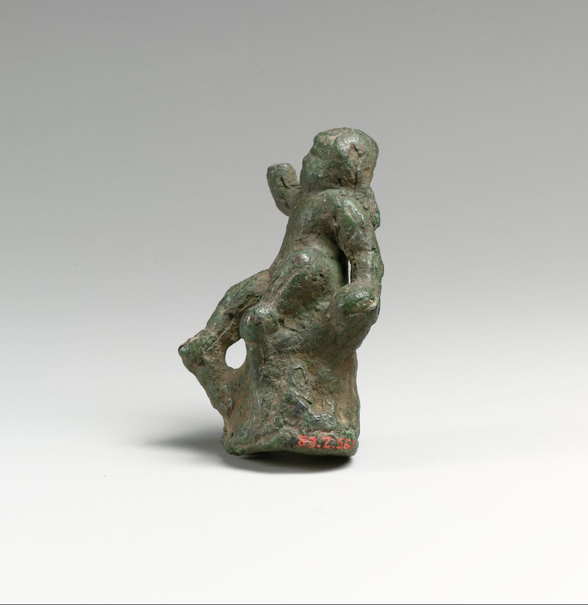 Bronze statuette of Eros seated on a rock, Bronze, Greek or Roman 