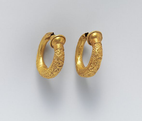 Gold trumpet-shaped earrings with relief decoration