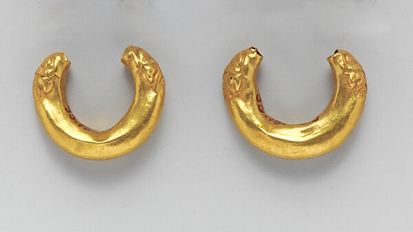 Gold boat-shaped earrings with lions' heads