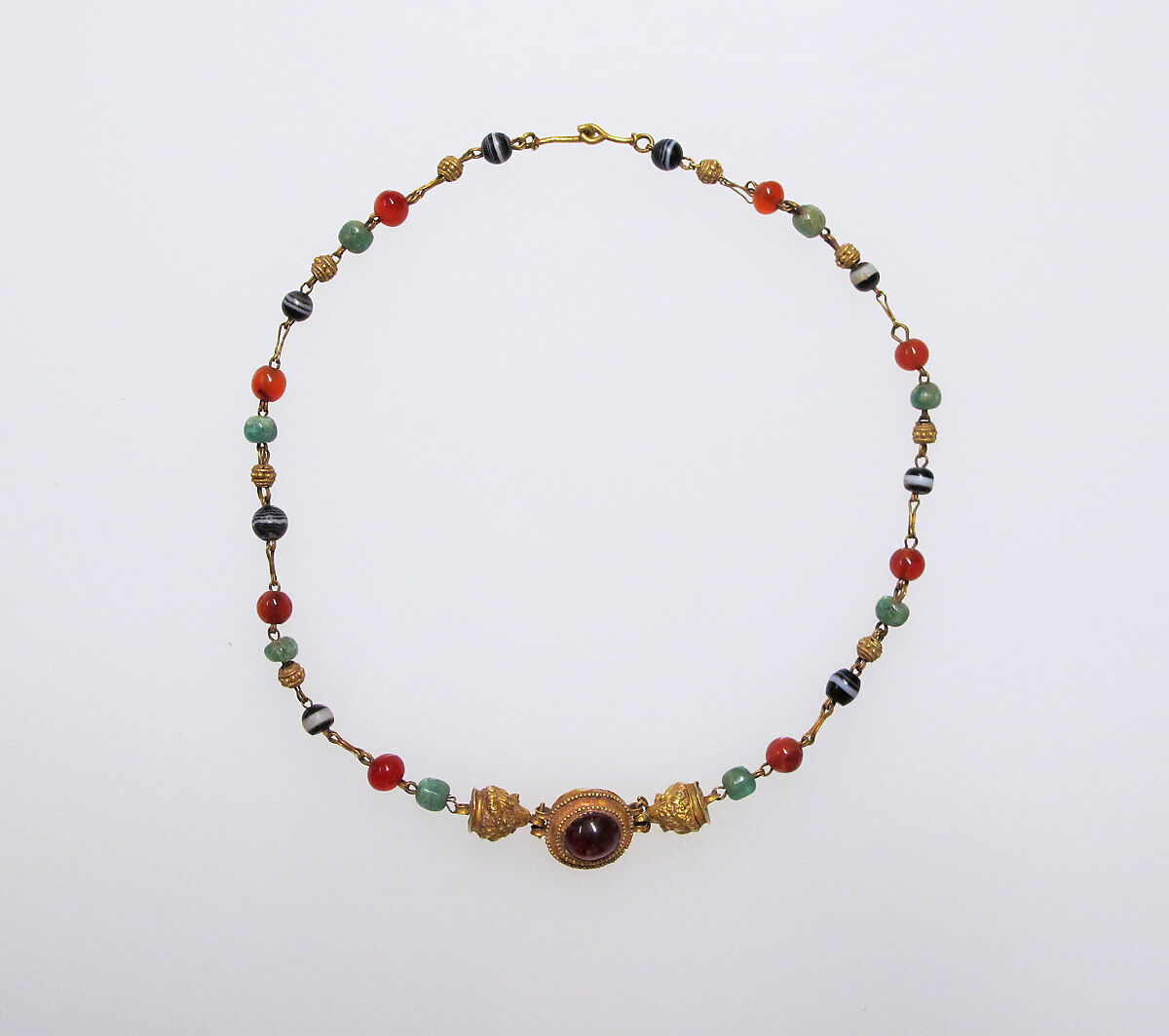 Gold, emerald, carnelian, banded onyx, and garnet necklace, Gold, emerald, carnelian, banded onyx, with central cabochon garnet, Roman 