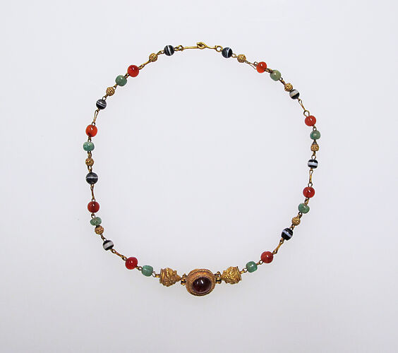 Gold, emerald, carnelian, banded onyx, and garnet necklace