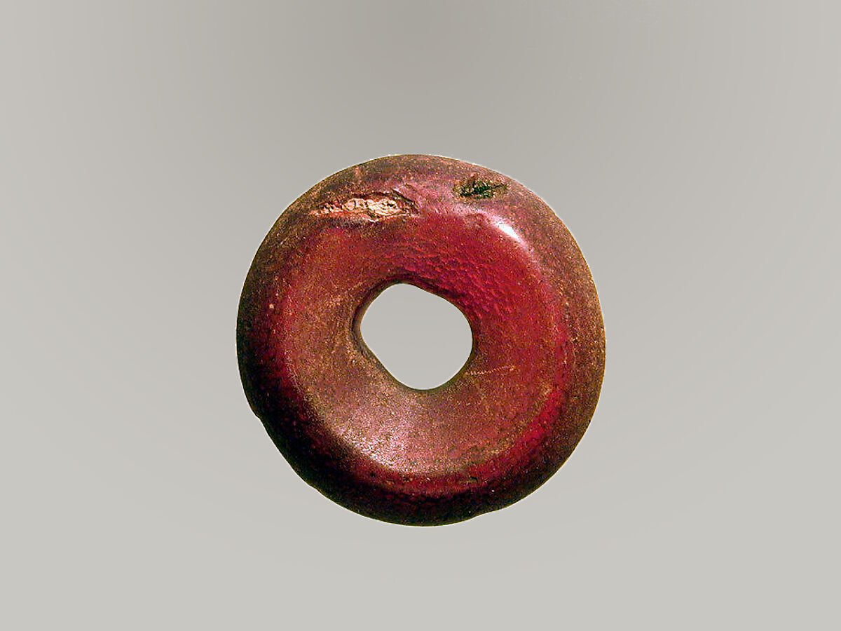 Pierced disk, perhaps from an earring or fibula (safety pin), Amber, Etruscan or Italic 